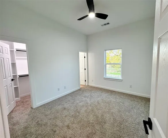 an empty room with windows and closet