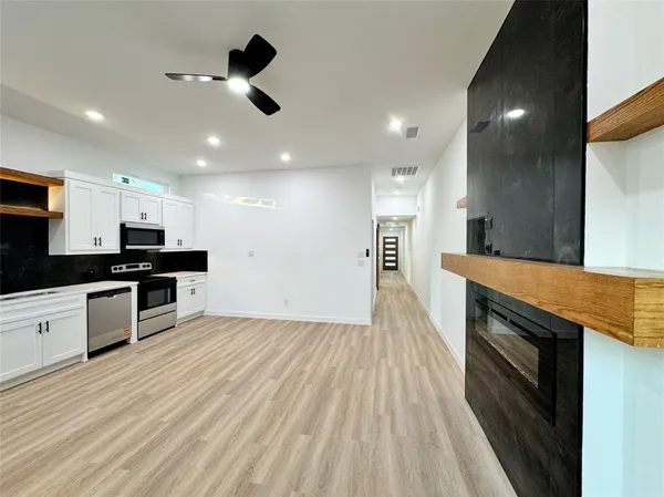 a kitchen with a sink stainless steel appliances and cabinets