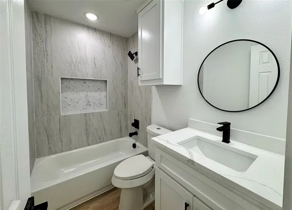 a bathroom with a sink a toilet and a mirror