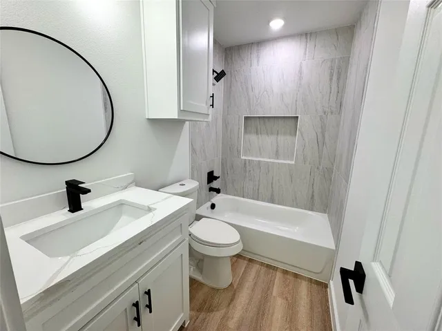 a bathroom with a sink a toilet and a mirror