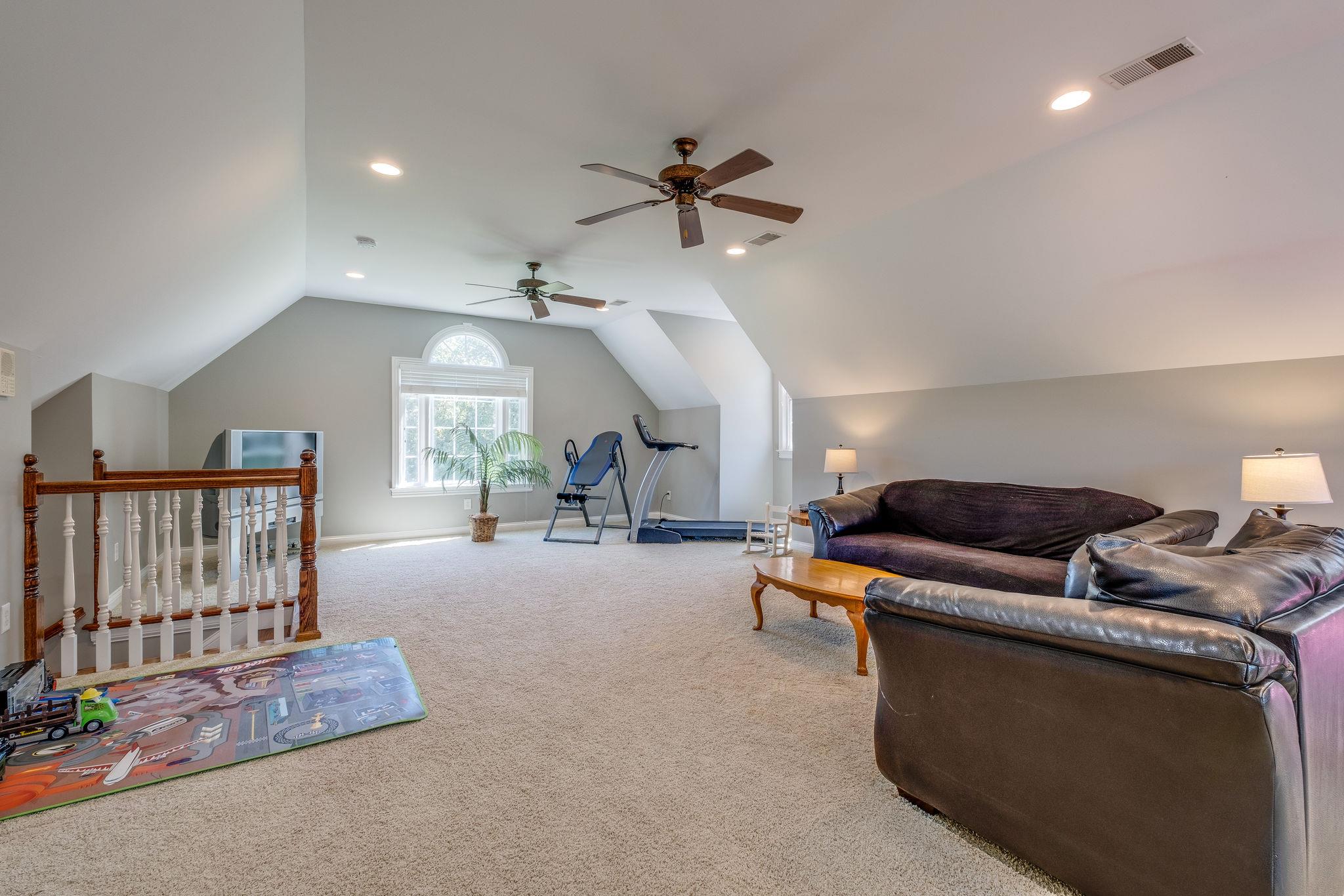471 Penny Morris Road Portland, TN 37148 - Photo 23 of 33 a living room with furniture and a chandelier