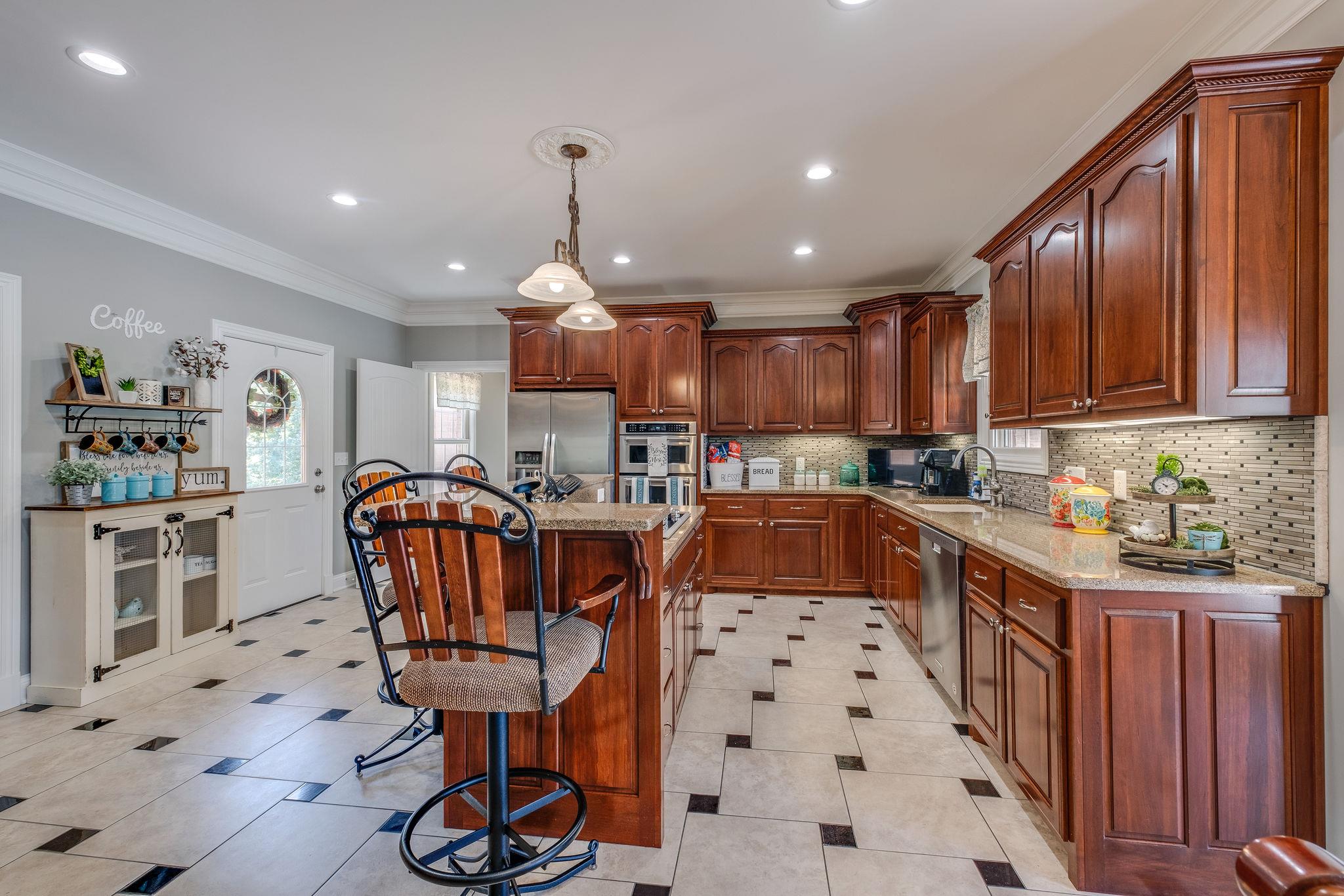 471 Penny Morris Road Portland, TN 37148 - Photo 8 of 33 a kitchen with granite countertop a sink a counter space stainless steel appliances and cabinets