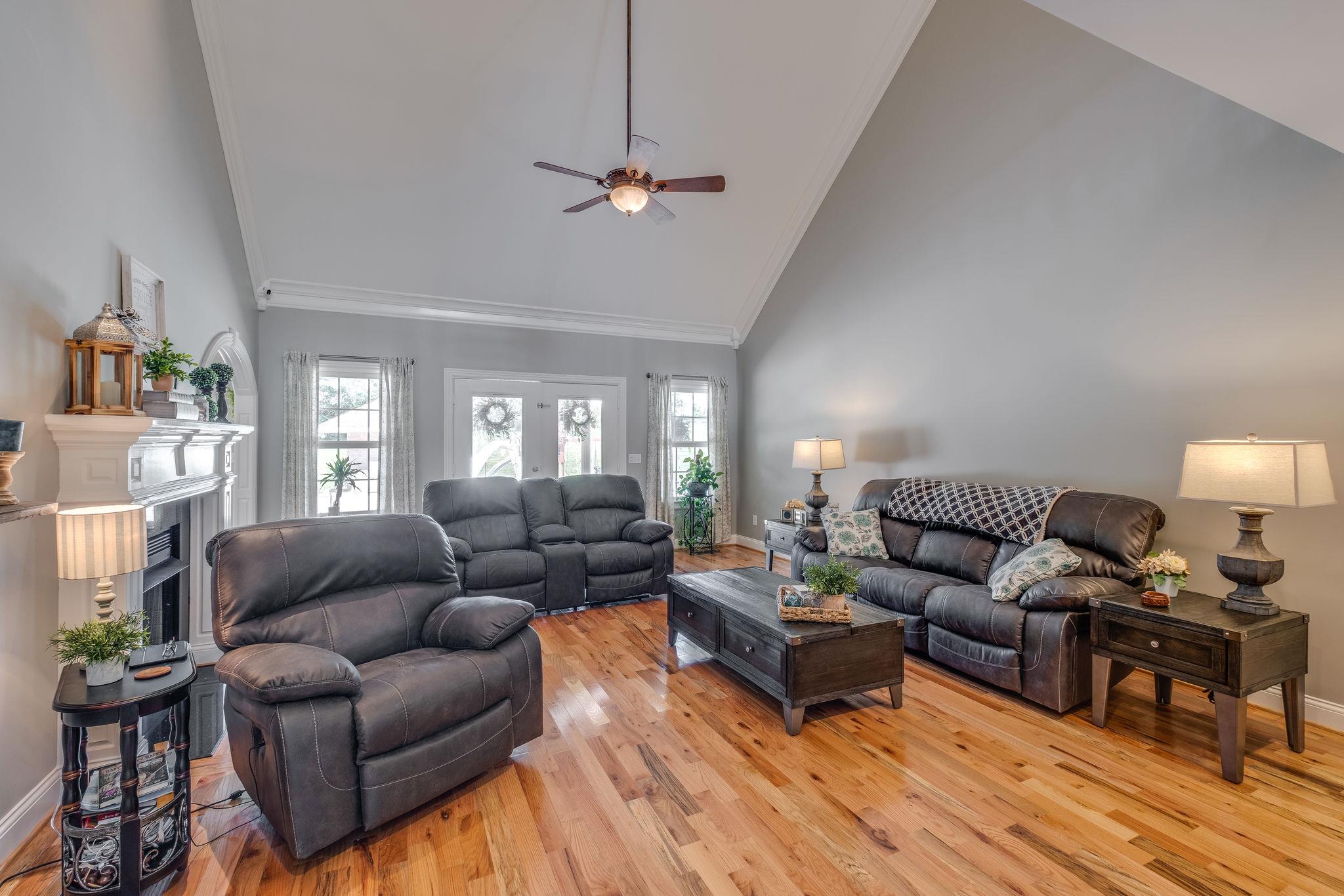 471 Penny Morris Road Portland, TN 37148 - Photo 10 of 33 a living room with furniture a ceiling fan a lamp and a window