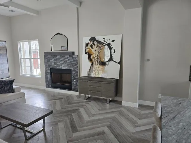 a living room with furniture a flat screen tv and a fireplace
