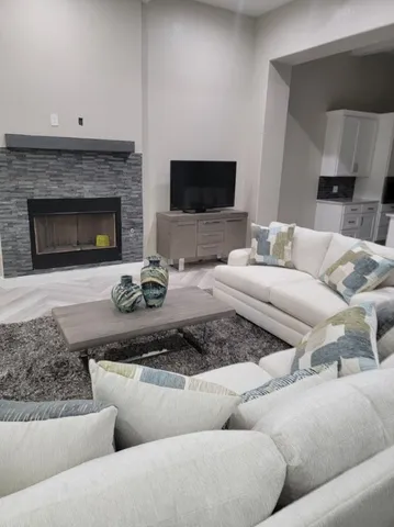 a living room with furniture a fireplace and a table