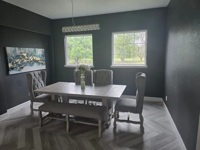 a living room with furniture a large window and table