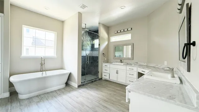 a bathroom with a bathtub and a shower