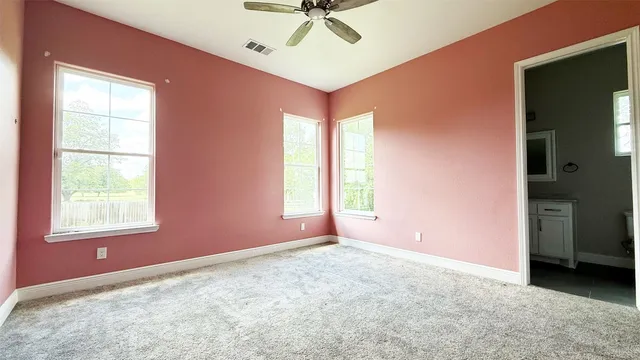 a spacious bathroom with a tub sink and mirror