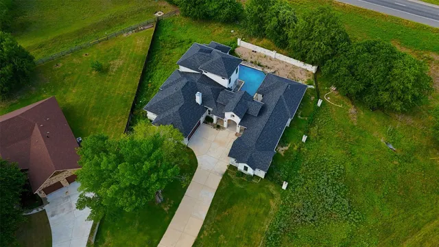 an aerial view of house with yard