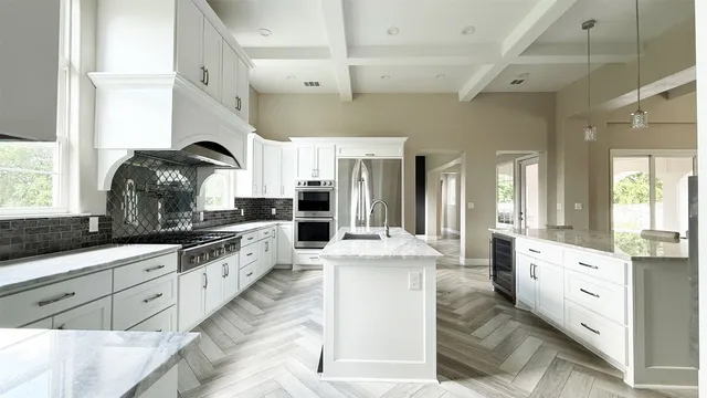 a kitchen with stainless steel appliances granite countertop a sink and cabinets