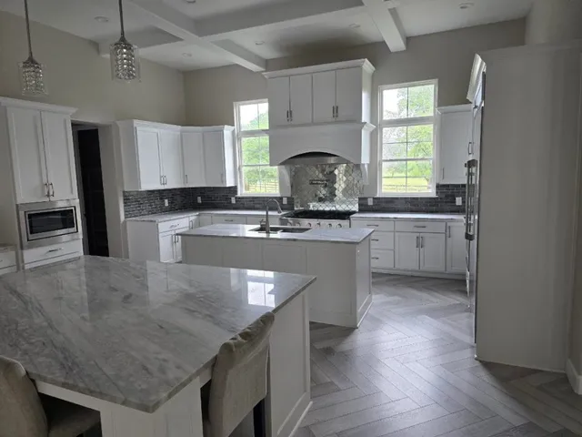 a view of a kitchen with a sink stainless steel appliances and cabinets