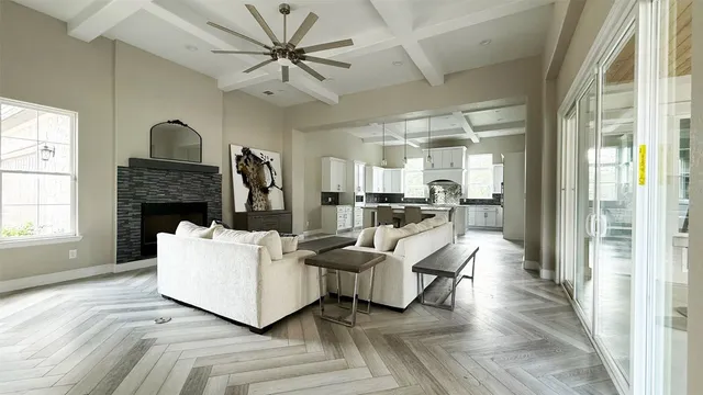 a living room with furniture and a chandelier