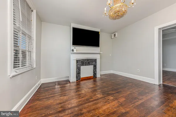 a living room with a fireplace and a flat screen tv