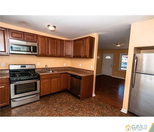 72 Sturgis Road Edison, NJ 08817 - Photo 1 of 15 a kitchen with stainless steel appliances kitchen island granite countertop a stove a sink and a refrigerator