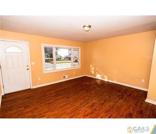 72 Sturgis Road Edison, NJ 08817 - Photo 12 of 15 a room with wooden floor and a window