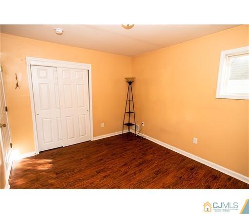 72 Sturgis Road Edison, NJ 08817 - Photo 8 of 15 a picture of an empty room with wooden floor