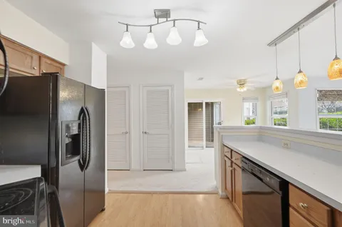 a kitchen with a refrigerator a sink and cabinets