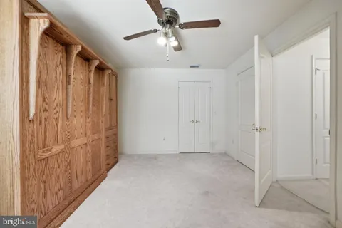 an empty room with cabinet and mirrors
