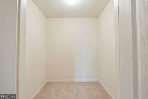 a bathroom with a double vanity sink a toilet a mirror and shower