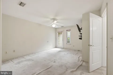 a view of a livingroom with a ceiling fan and window