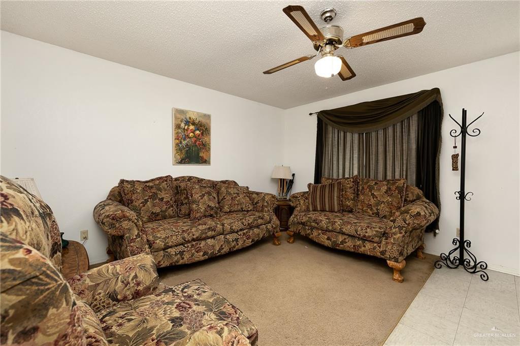 2201 South Jackson Road, Unit 9J Pharr, TX 78577 - Photo 2 of 21 a living room with furniture and a ceiling fan