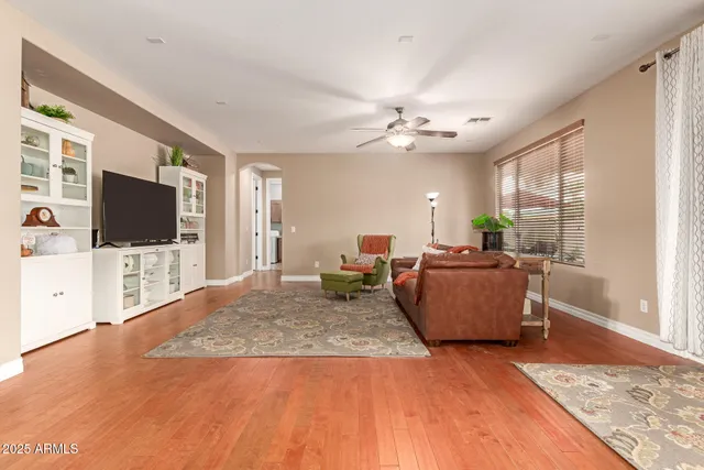 a dining room with furniture a chandelier and wooden floor