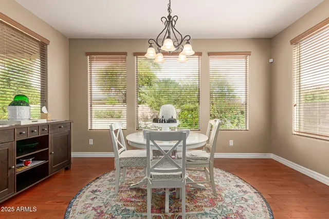 a kitchen with a dining table chairs refrigerator and cabinets