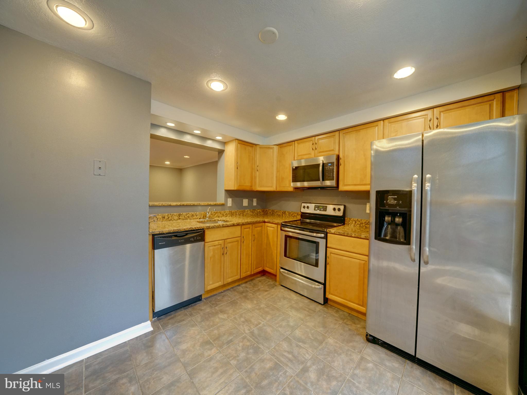 a kitchen with a refrigerator and a sink