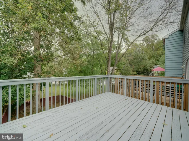 a balcony with wooden floor and fence