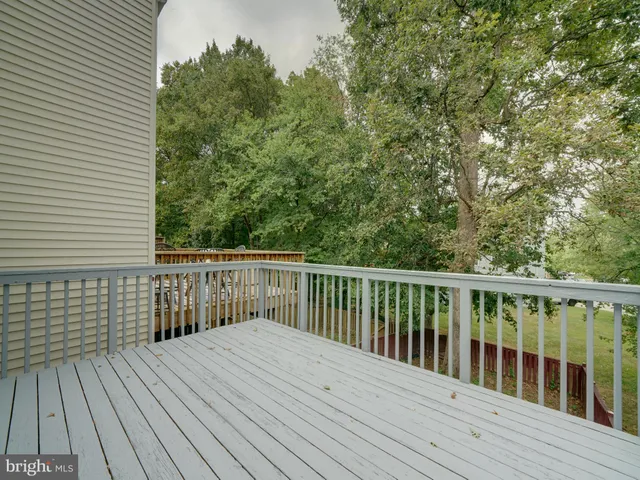 a balcony with wooden floor and fence