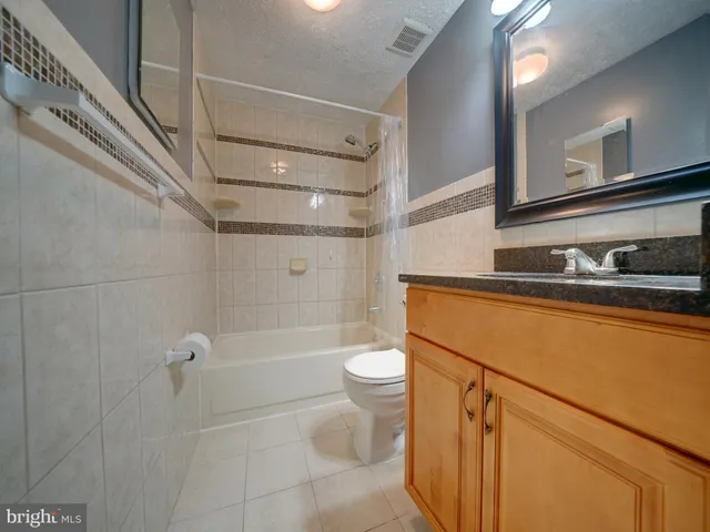 a bathroom with a shower a sink and toilet