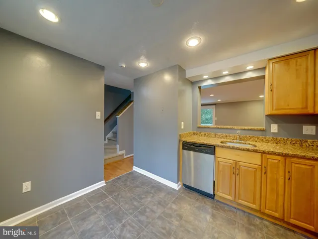 a view of a kitchen with a sink and a refrigerator