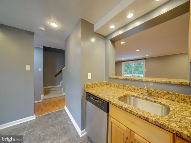 a bathroom with a granite countertop sink and a granite counter top