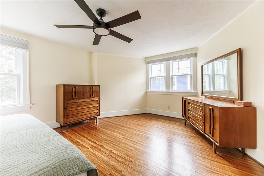 55 Elm Drive Rochester, NY 14609 - Photo 20 of 31 Another view of the large Primary Bedroom with ceiling fan and beautifully refinished hardwood floors