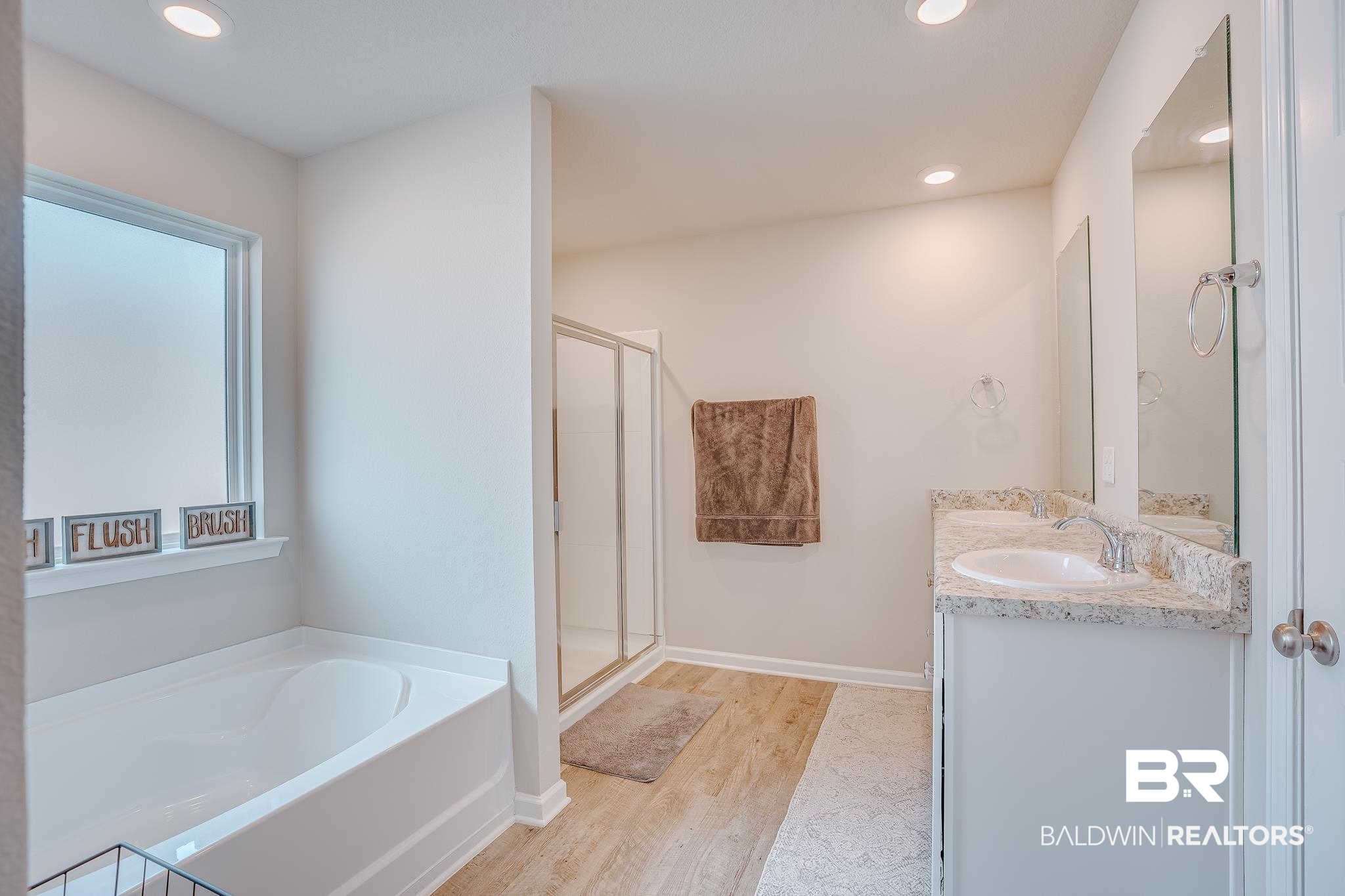 8242 Sycamore Way Semmes, AL 36575 - Photo 24 of 43 Bathroom featuring double vanity, a bath, wood finished floors, a stall shower, and recessed lighting