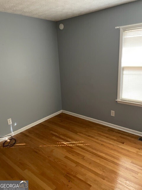 468 Davis Road Fayetteville, GA 30215 - Photo 11 of 13 a view of empty room with wooden floor