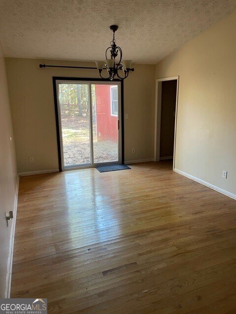 468 Davis Road Fayetteville, GA 30215 - Photo 4 of 13 a view of empty room with wooden floor and fan