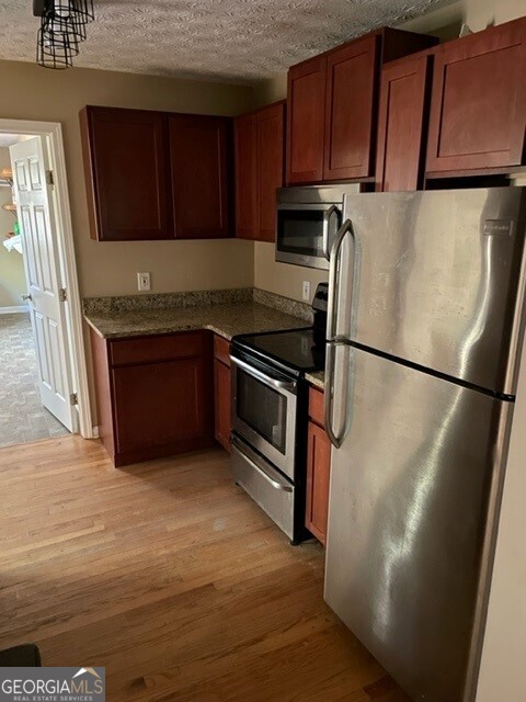 468 Davis Road Fayetteville, GA 30215 - Photo 6 of 13 a kitchen with stainless steel appliances granite countertop a refrigerator microwave and sink