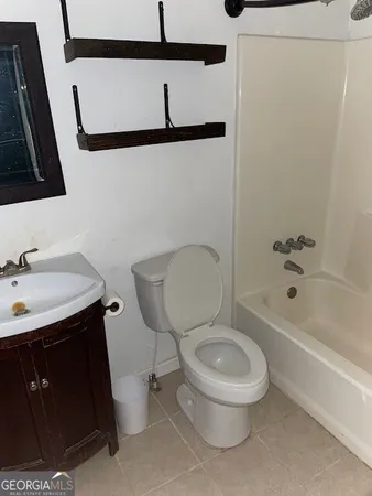 a bathroom with a toilet a sink and a bathtub