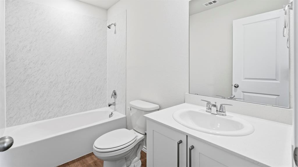 3319 Twilight Trail Forney, TX 75126 - Photo 32 of 33 Bathroom featuring a white bathtub, a toilet, and a vanity with a white countertop