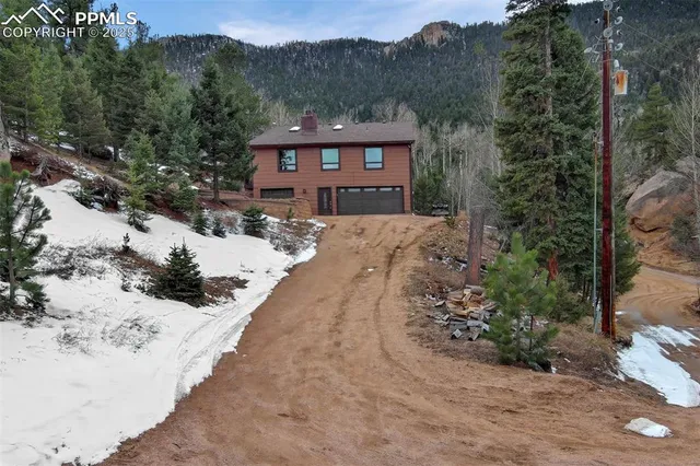 a view of a house with a yard covered in snow