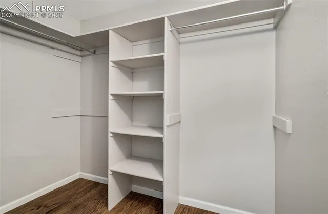 a view of walk in closet with empty racks