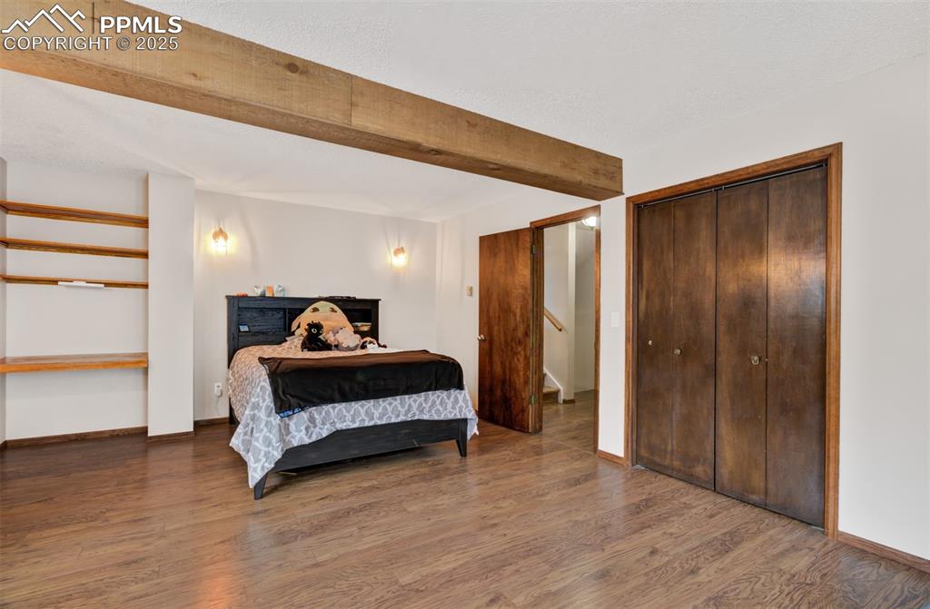 5865 Waterfall Loop Manitou Springs, CO 80829 - Photo 27 of 45 a view of bedroom with furniture and wooden floor