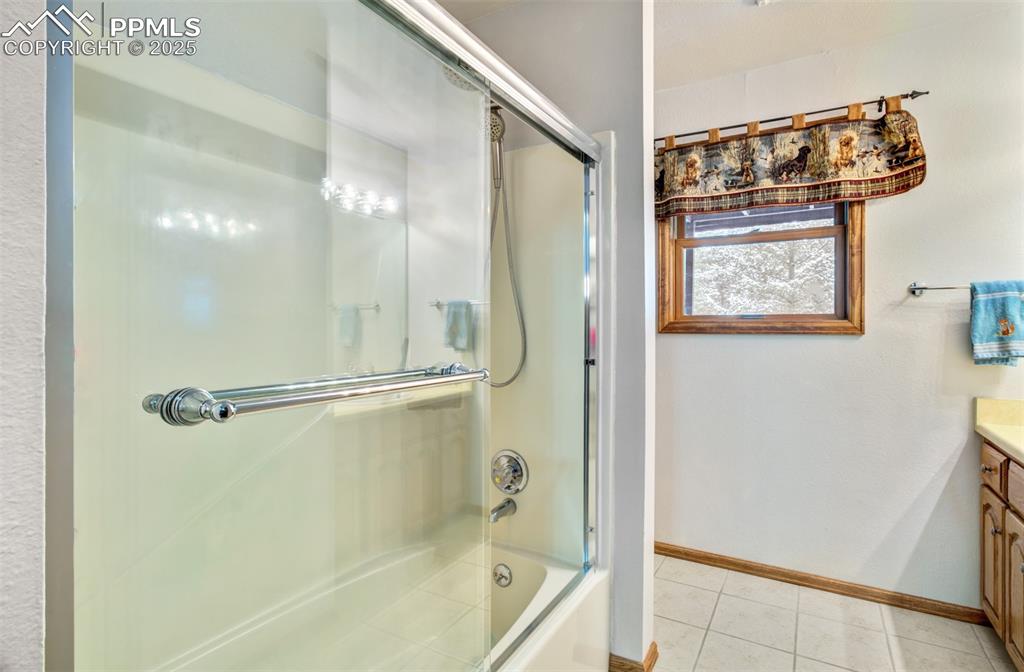 5865 Waterfall Loop Manitou Springs, CO 80829 - Photo 29 of 45 a bathroom with a shower and a glass door
