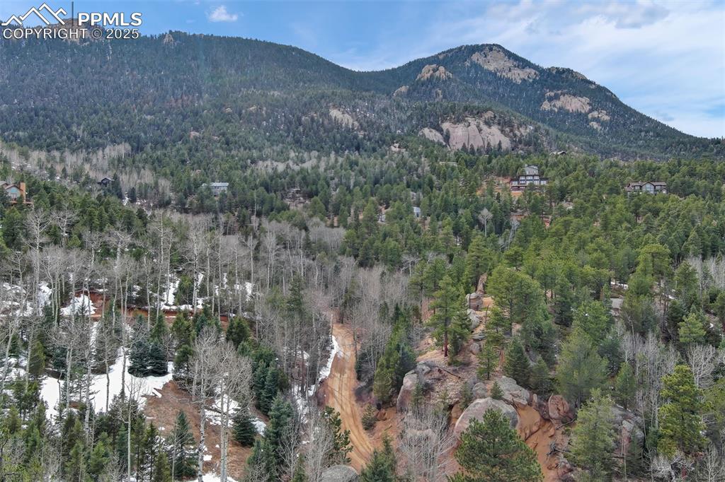 5865 Waterfall Loop Manitou Springs, CO 80829 - Photo 35 of 45 a view of a house with a mountain and a forest