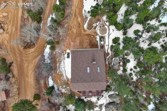 an aerial view of a house with a yard