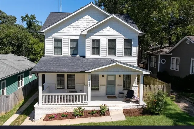 a front view of a house with a yard table and chairs