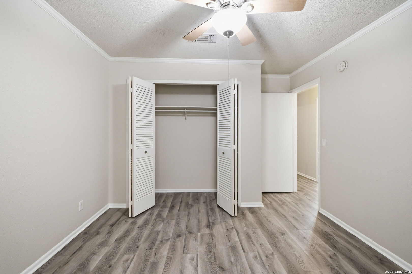 6106 Vance Jackson Road, Unit 15 San Antonio, TX 78230 - Photo 19 of 30 a view of an empty room with wooden floor