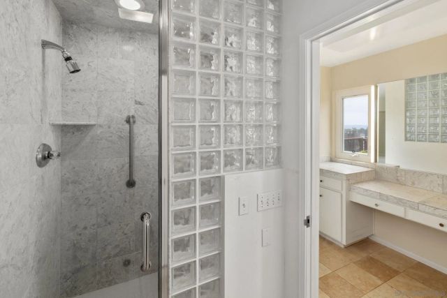 a bathroom with a granite countertop sink a shower and a mirror
