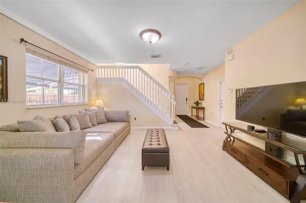 a living room with furniture and a flat screen tv